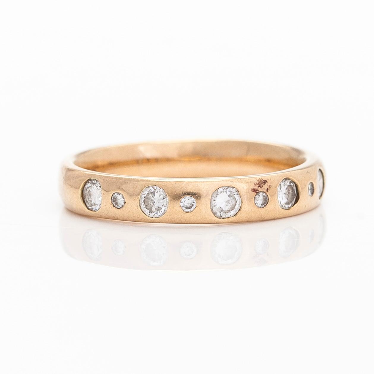 A 14K gold half eternity ring, set with brilliant-cut diamonds, total approximately 0.26 ct. Finnish import marks  1997.