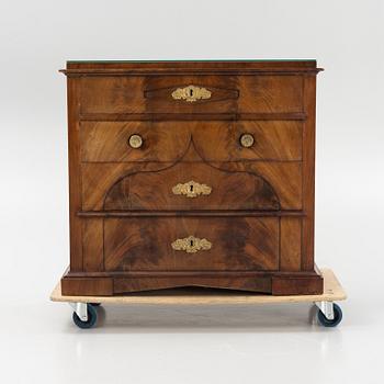 A mahogany veneered Empire chest of drawers, first half of the 20th Century.