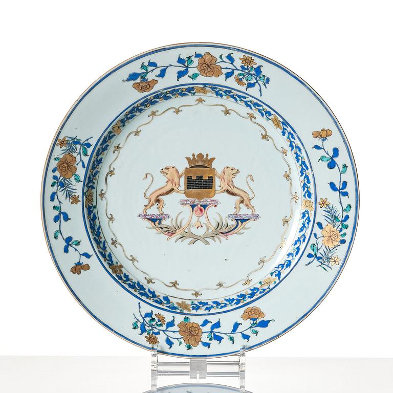 A Chinese Export armorial dish and seven plates, Qing dynasty, 18th Century.