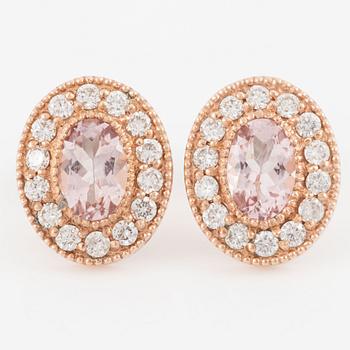 A pair of 14K gold earrings with faceted morganites and round brilliant-cut diamonds.