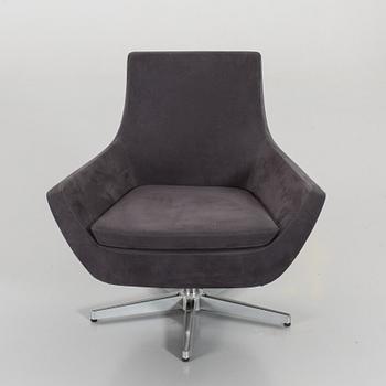 A SWEDESE SWIVEL ARMCHAIR.