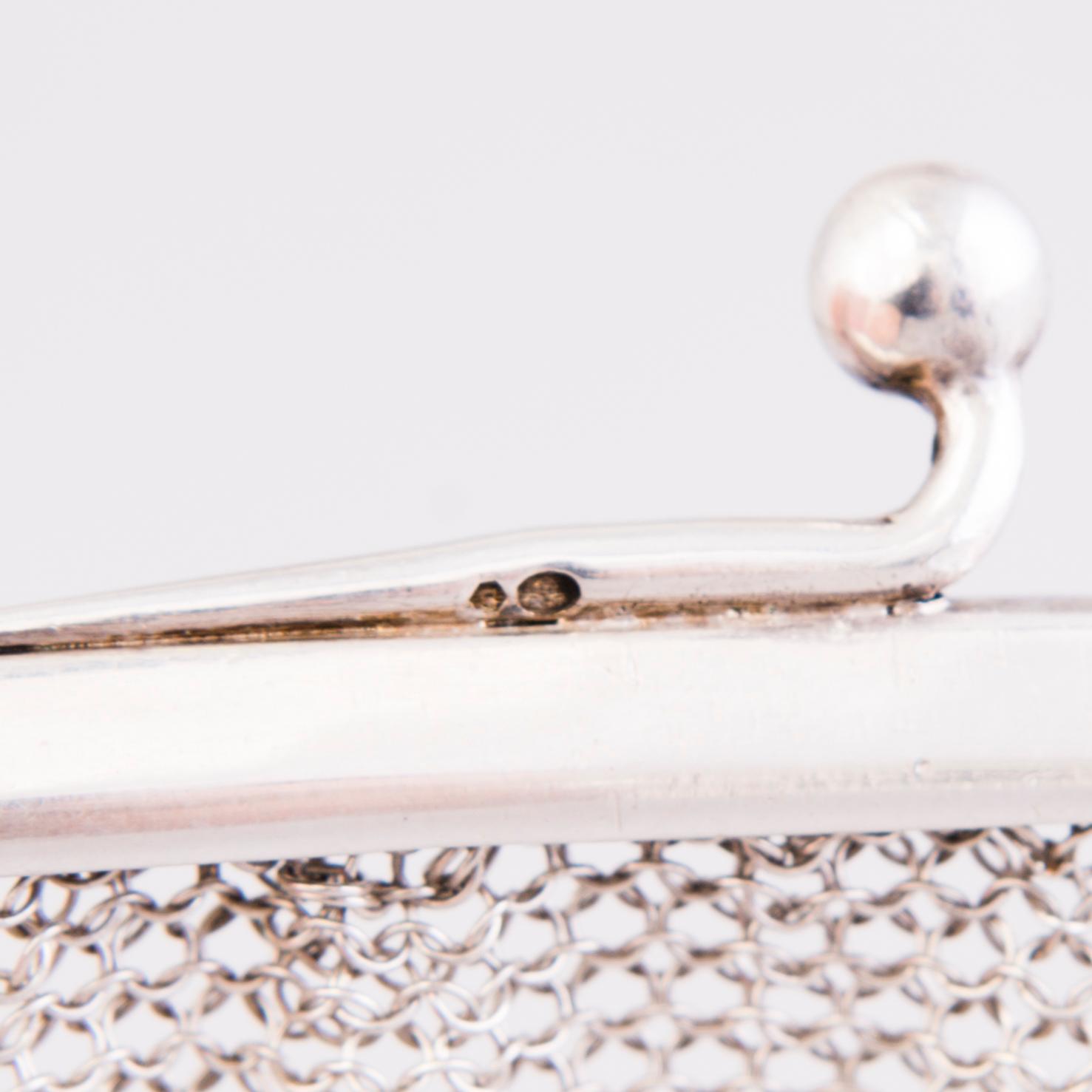 Two silver evening bags and a silver mirror, 1920s-1940s.