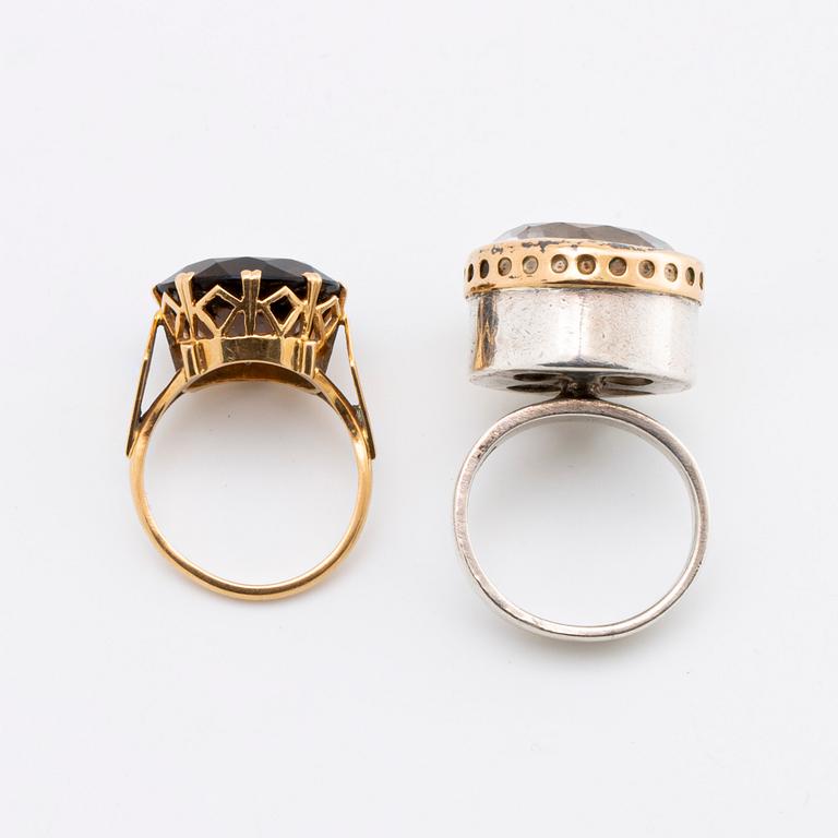 2 RINGS, 18K gold w smoky quartz approx 14 mm, silver and gold w rock crystal approx 16 mm, Stockholm 1963.