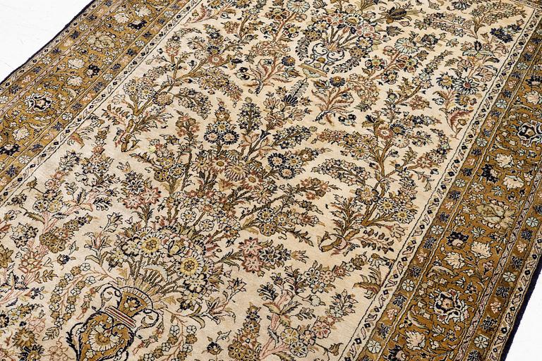 A Ghom, silk rug, c. 215 x 140 cm.