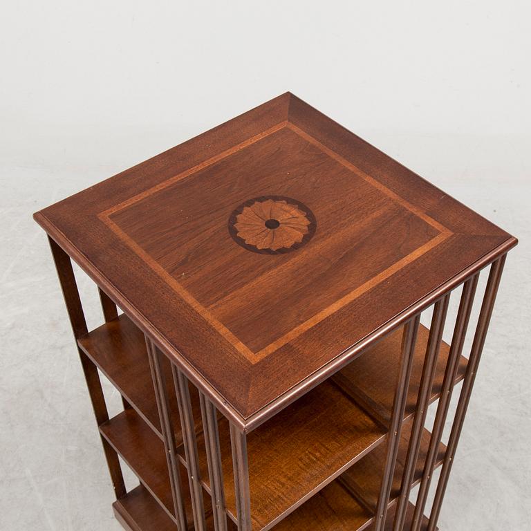 A 20th century mahogany veneer swivel bookshelf.