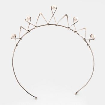 A silver tiara set with pearls.