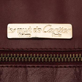 A set of two 1970s bordeaux leather handbags by Cartier.