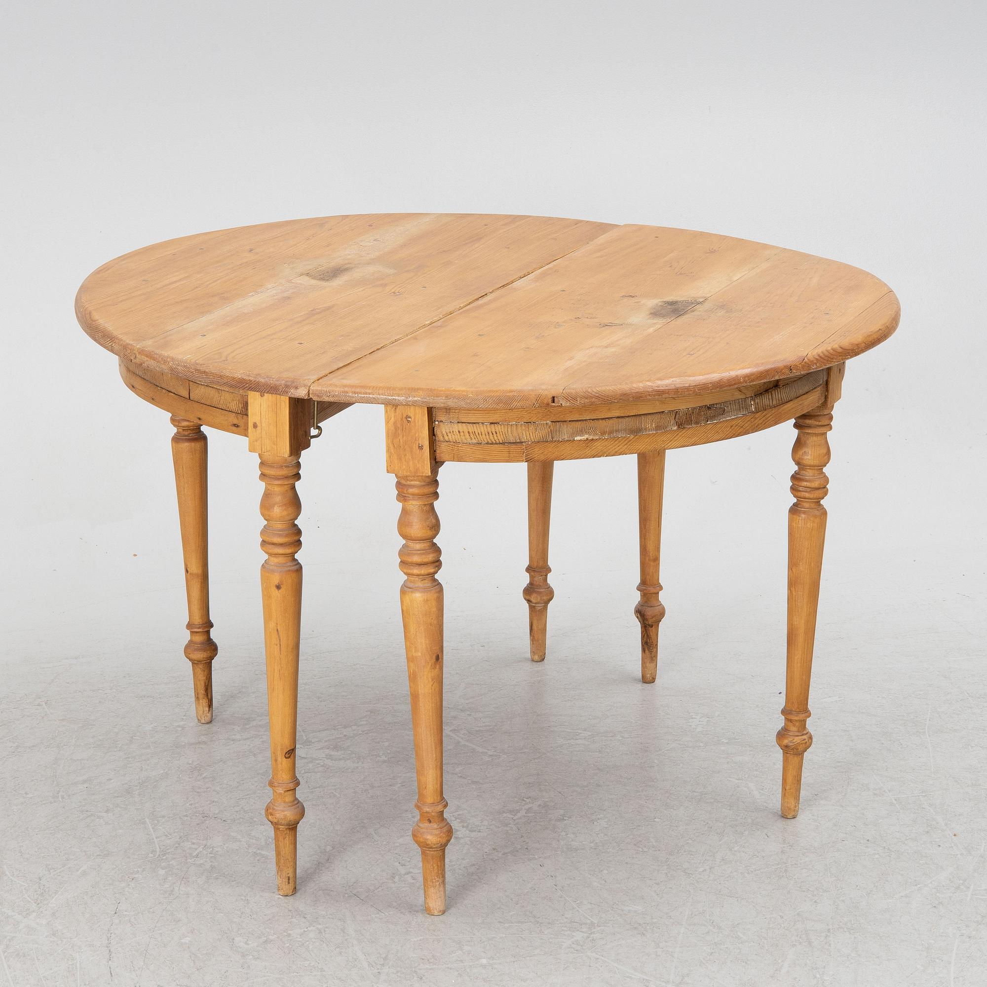 A round pine dining table/a pair of crescent shaped tables, Sweden, 19th century.