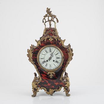 A Louis XV-style 'faux tortoise' and gilt brass-mounted striking mantel clock, late 19th century.