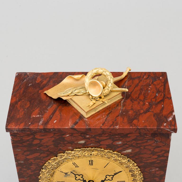 AN EMPIRE ORMOLU AND MARBLE MANTEL CLOCK, first half of the 19th century.