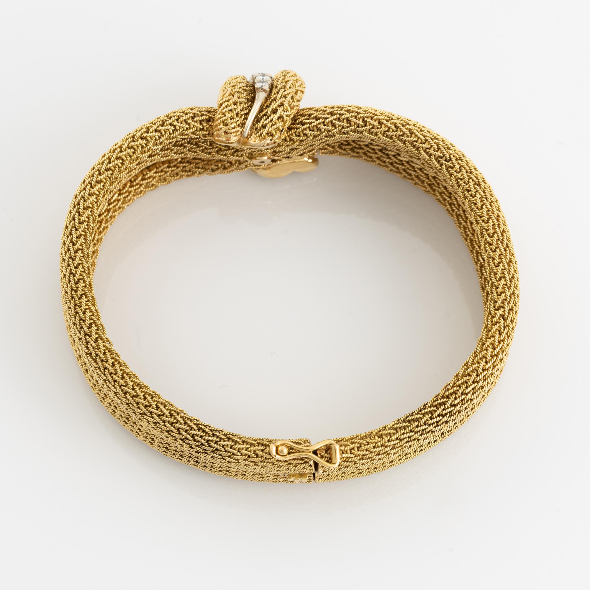 An 18K gold Bucherer bracelet set with round brilliant-cut diamonds.