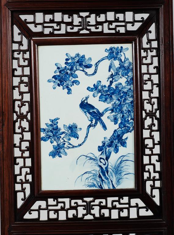 A four panel screen with porcelain placques, Qing dynasty, 19th Century.