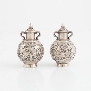 A pair of Chinese silver shakers, late Qing dynasty.