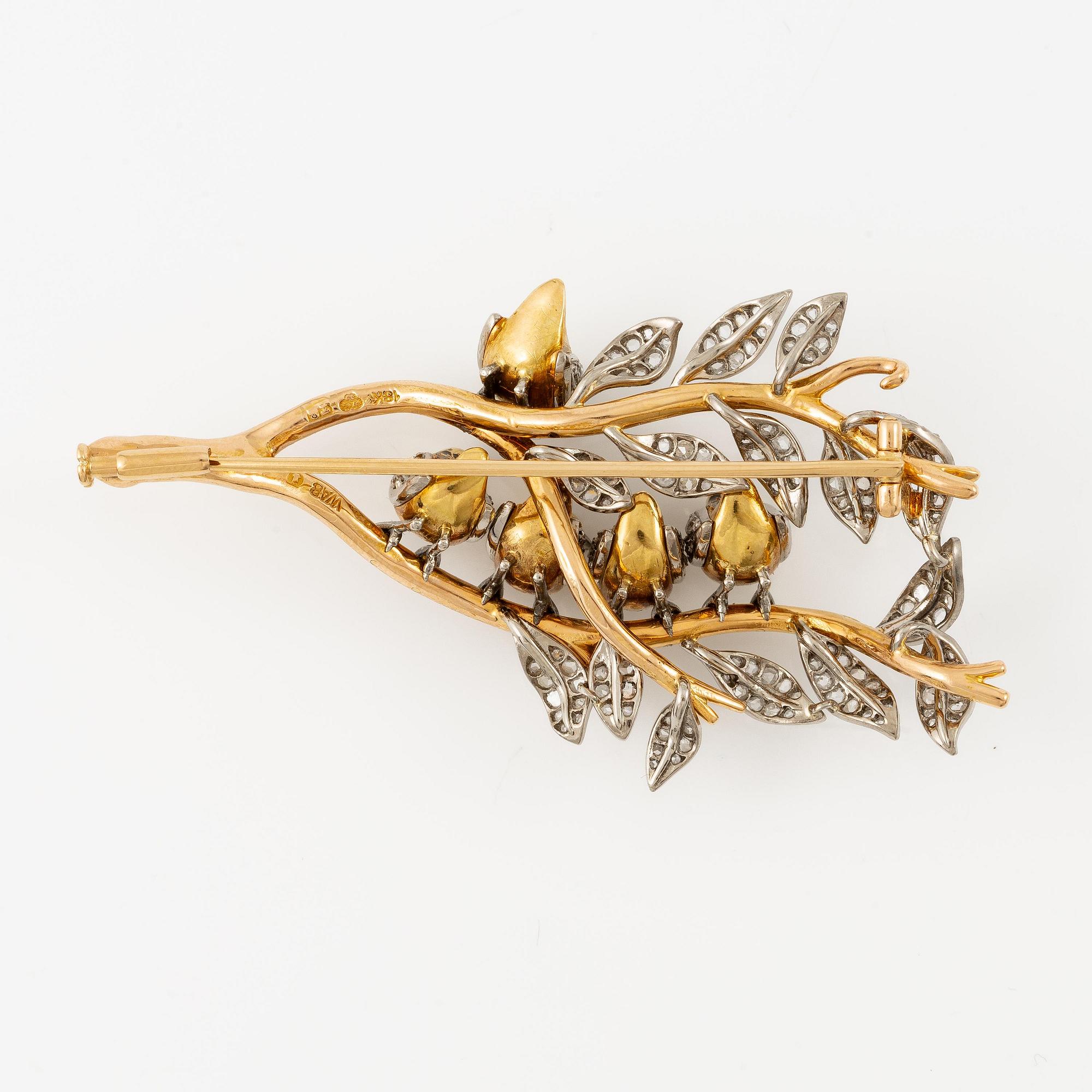 A W.A. Bolin brooch in 18K gold with enamel details and rose-cut diamonds.