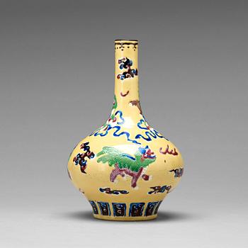 774. A yellow glazed vase with buddhist lions, Qing dynasty, 19th Century.