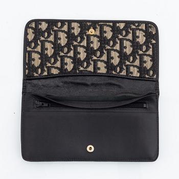 Christian Dior, a black canvas umbrella, toilet bag, coin purse and wallet.