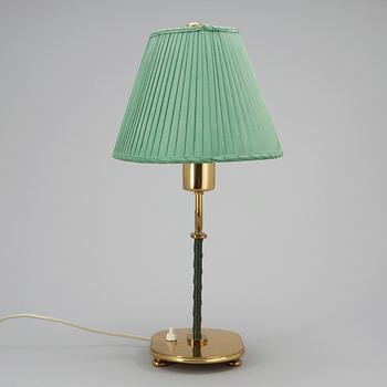 A Josef Frank brass and green leather table lamp by Svenskt Tenn.