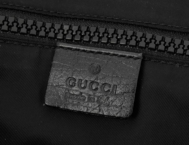 A black monogram canvas bag by Gucci.