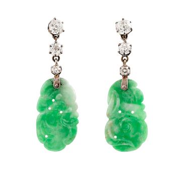 A pair of 18K white gold earrings with carved jadeite set with old-cut diamonds.