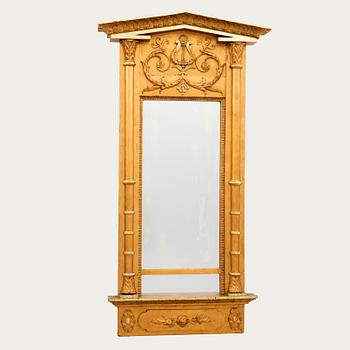 A mid 1800s gilded Empire mirror.