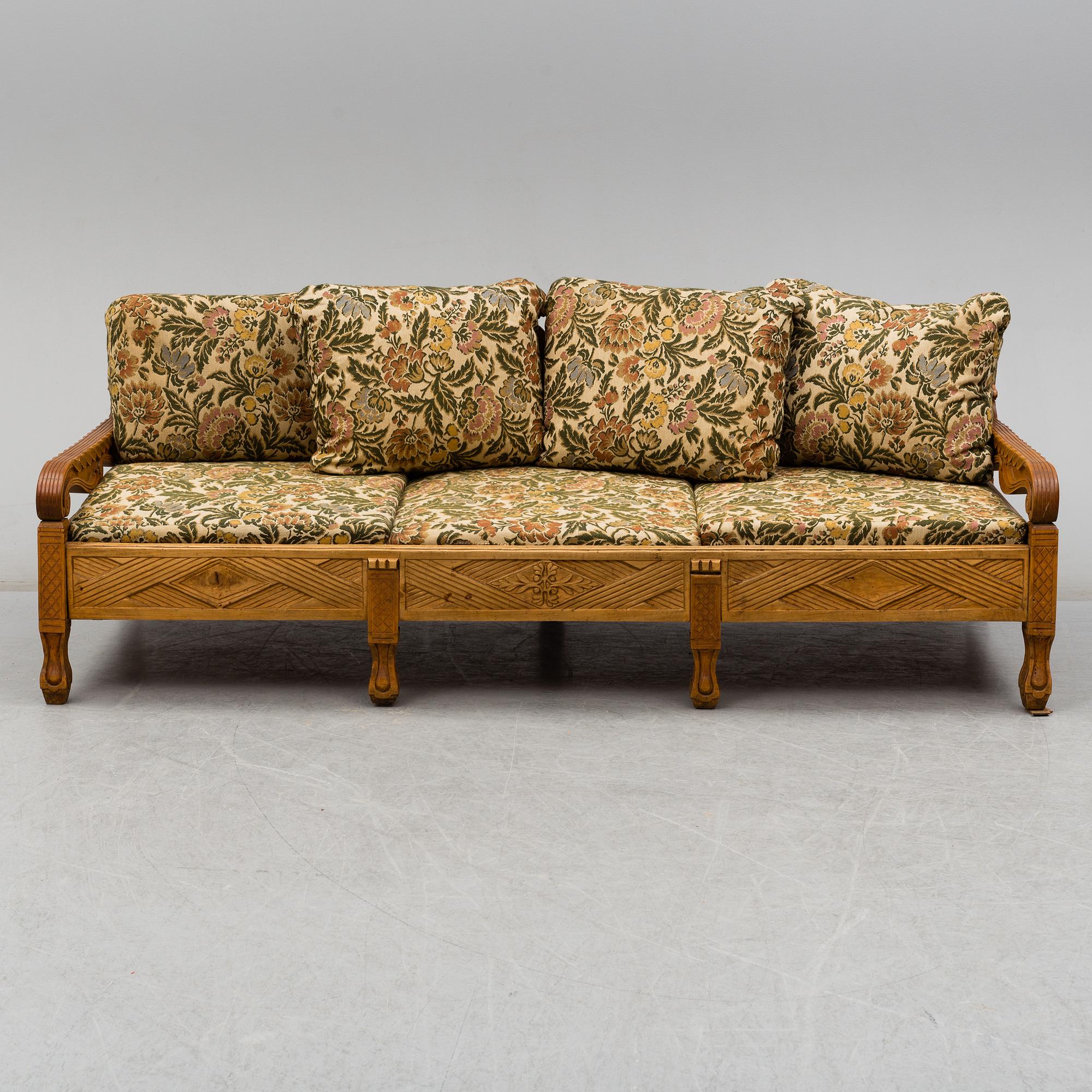 KNUT FJAESTAD, a folk art stained wood sofa/bed,  Sweden, early 20th C.