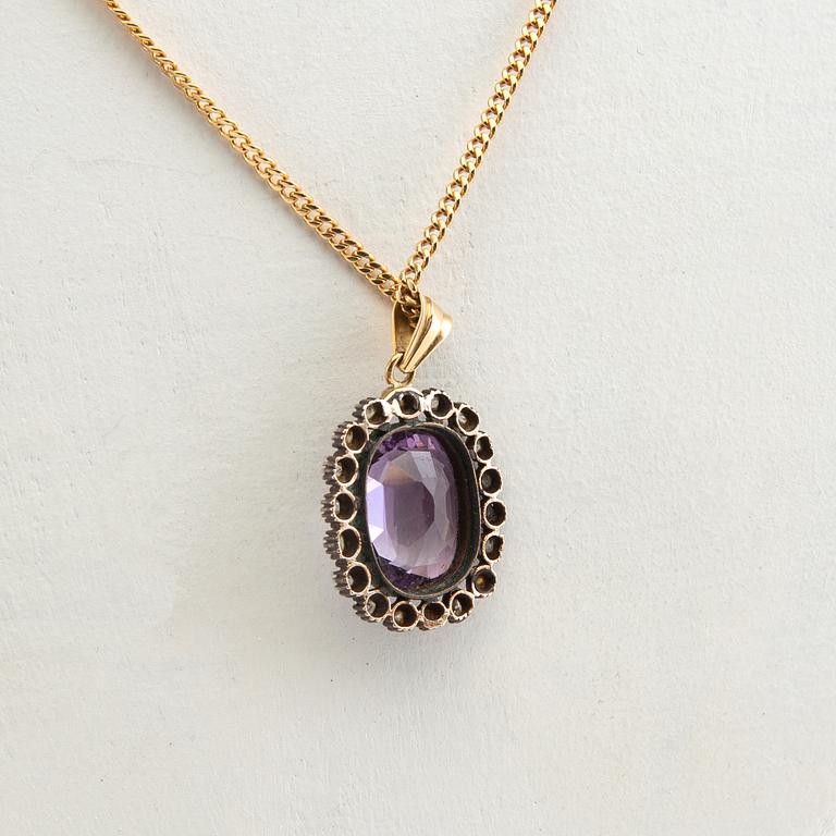 Pendant, 18k gold with diamonds and purple stone.