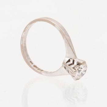 An 18K white gold solitaire ring set with a round brilliant cut diamond.