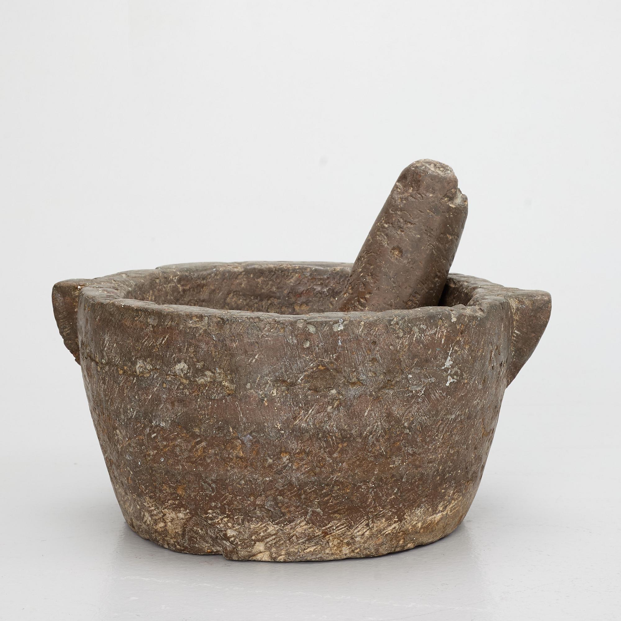 A llimestone mortar and pestle, 18th/19th Century.