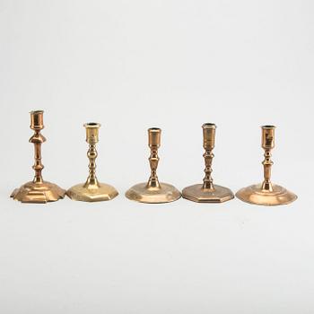 A set of five different brass late Baroque candlesticks.