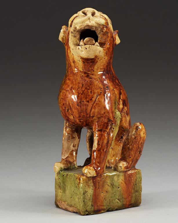 A potted figure of a 'Buddhist Lion', Tang dynasty (618-907).
