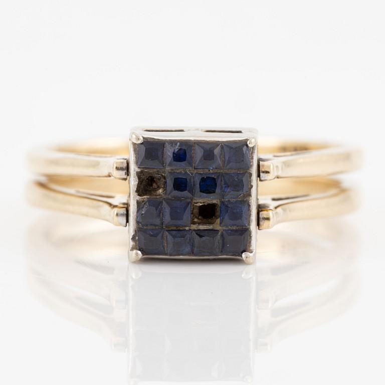Ring in 14K gold set with princess-cut diamonds and blue stones.