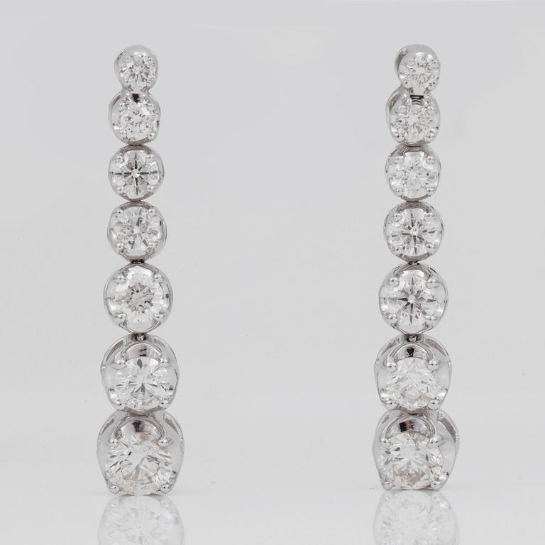 A line-necklace and matching earrings set with brilliant-cut diamonds.