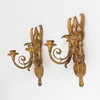 A pair of bronze two light wall-lights, early 20th century.