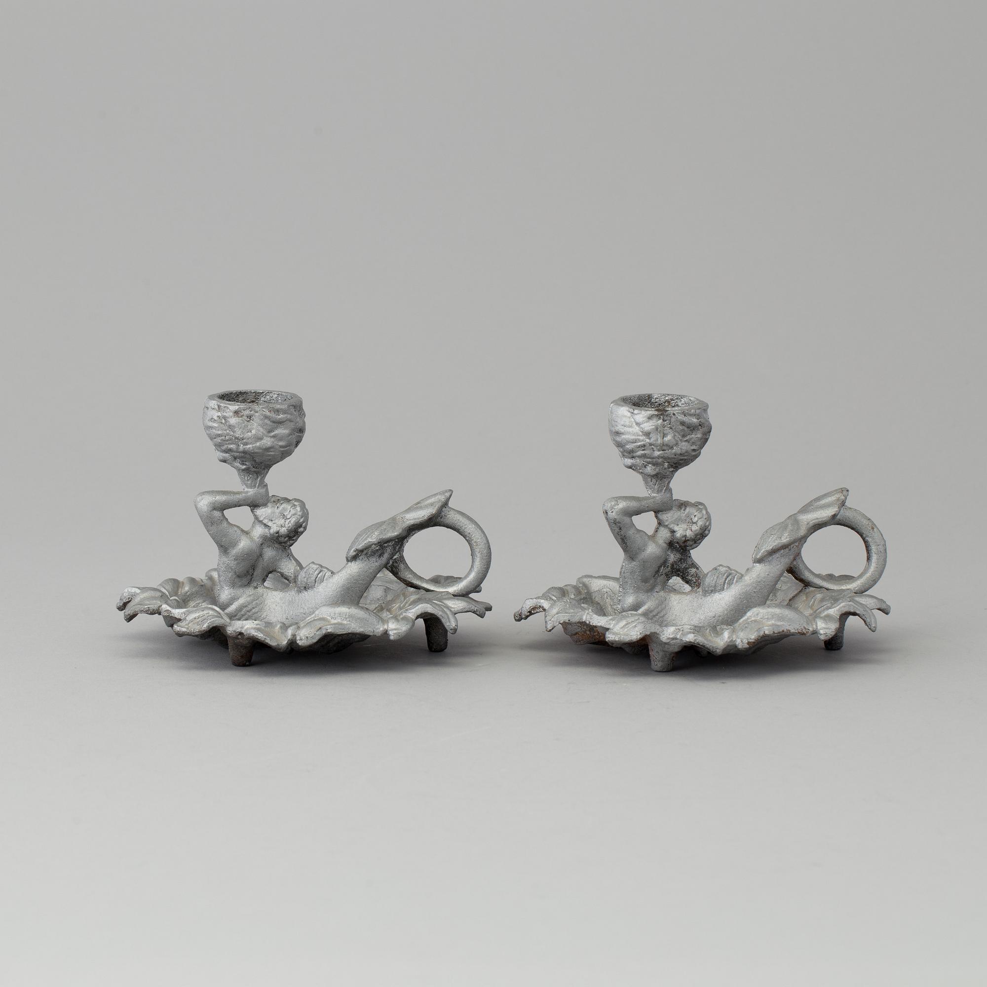 A pair of cast iron candlesticks, marked Verlag bei, A. Meves, Berlin, late 20th century.