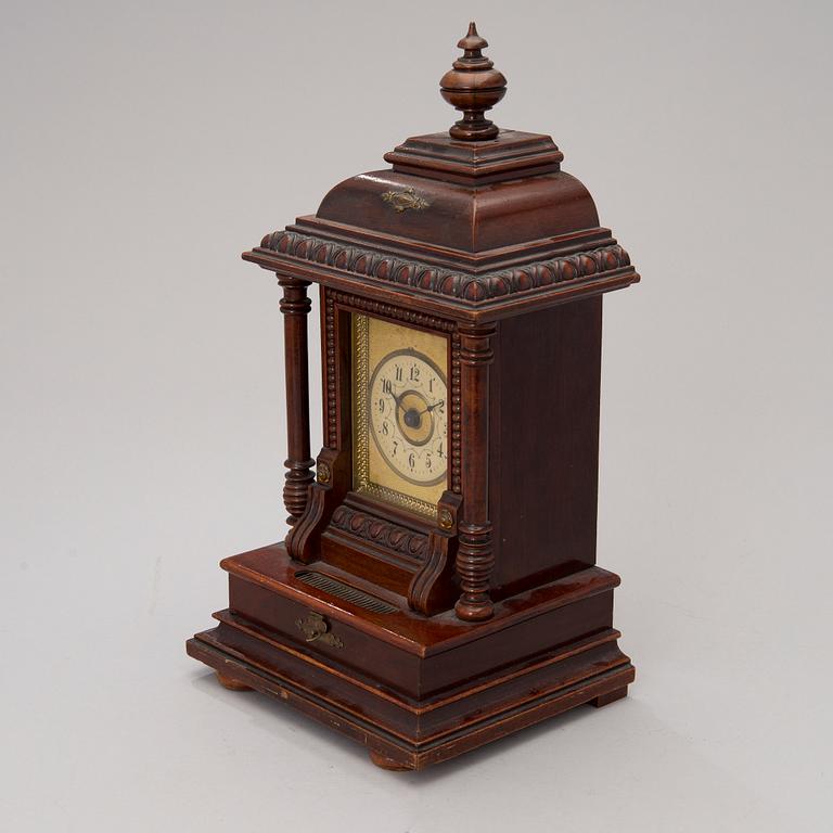 An early 20th century German Junghans table clock with music box.