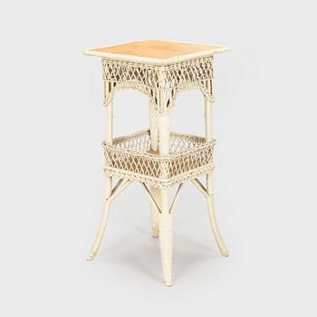 A mid-20th-century three-piece rattan furniture set including two armchairs, and a table.