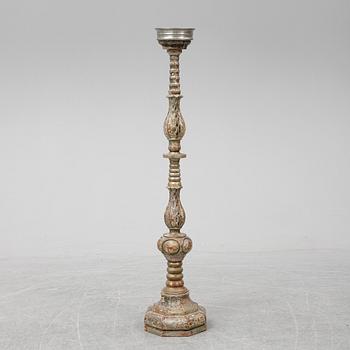 A wooden altar candlestick.