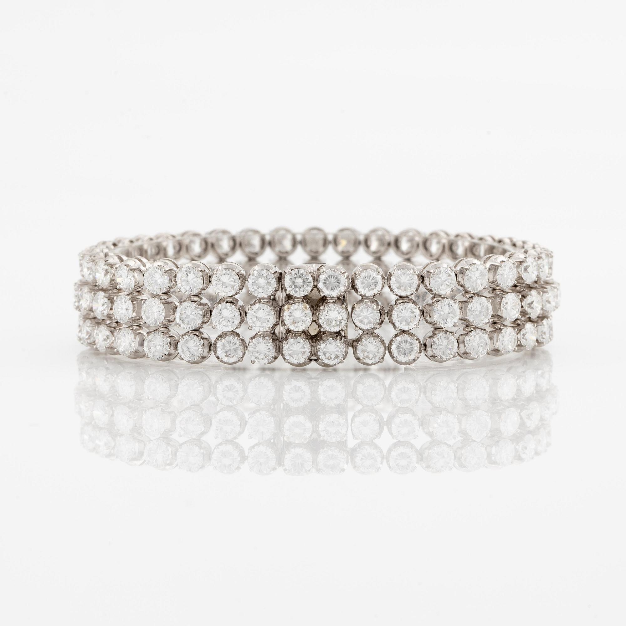 A platinum bracelet set with round brilliant-cut diamonds.