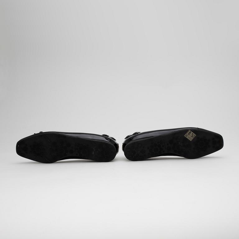 JIMMY CHOO, a pair of black ballerina shoes.