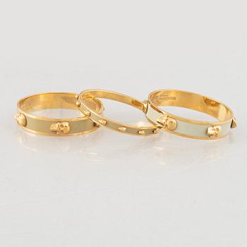 Alexander McQueen, three bracelets and a ring.
