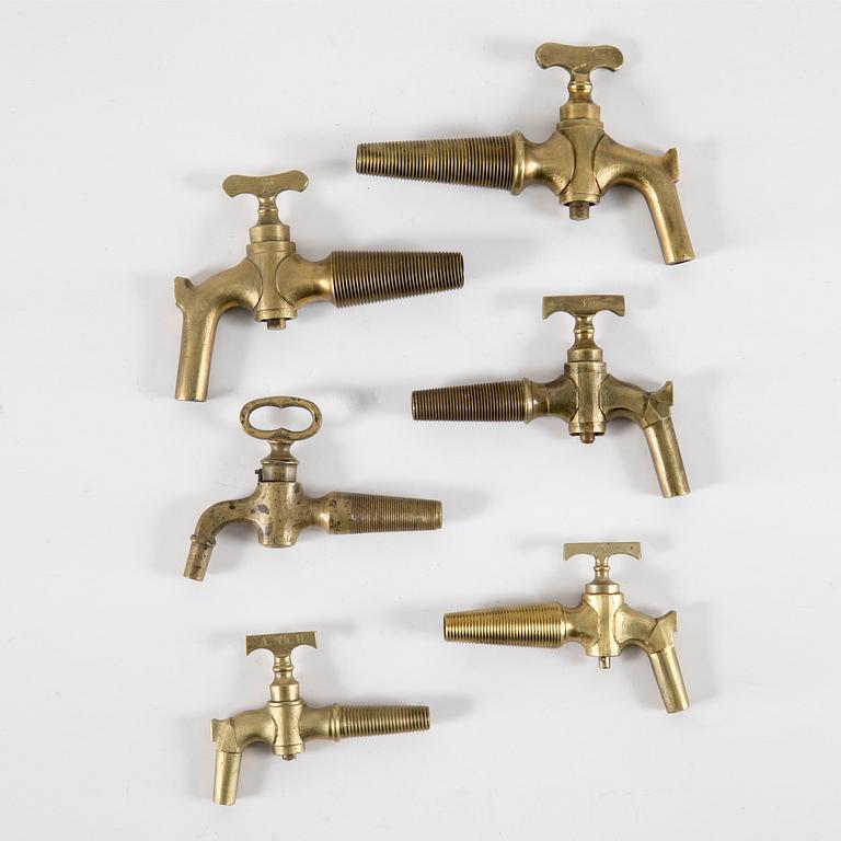 A set of six brass taps, 20th century.