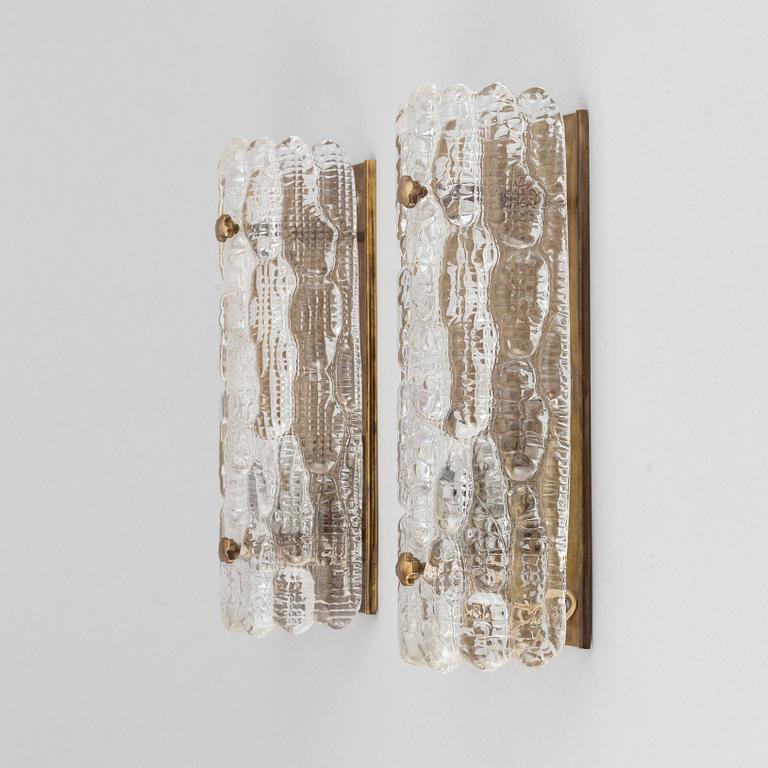 Carl Fagerlund, a pair of glass and brass wall sconces, Orrefors, second half of the 20th Century.
