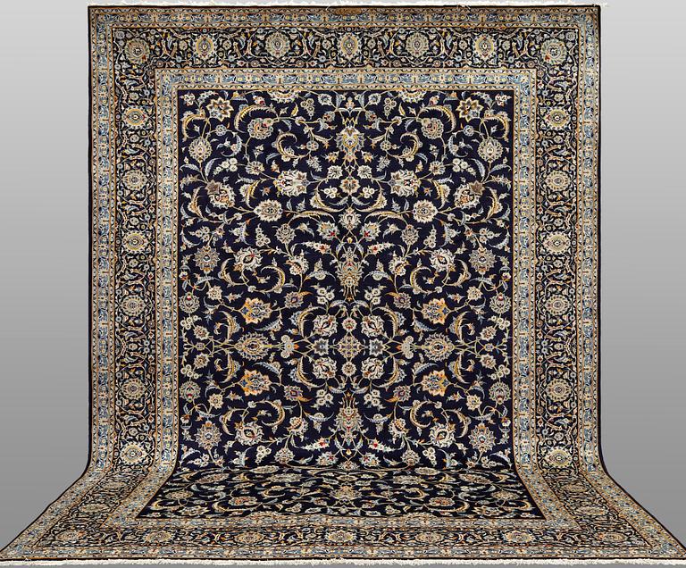 A Keshan carpet, signed, approx. 430 x 320 cm.