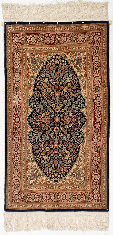 A Hereke silk rug, c. 130 x 71 cm.