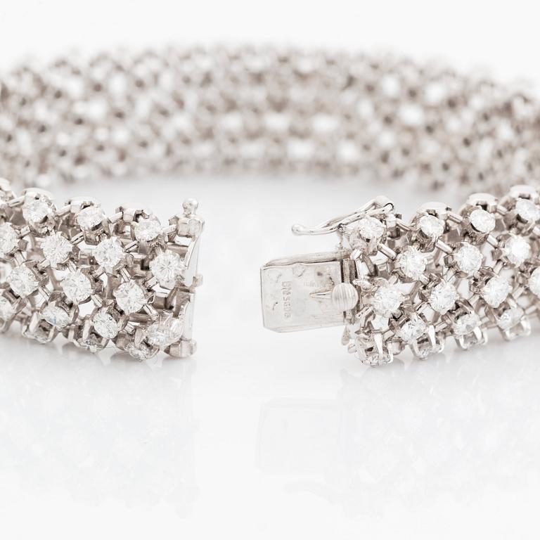 A platinum bracelet set with round brilliant-cut diamonds.