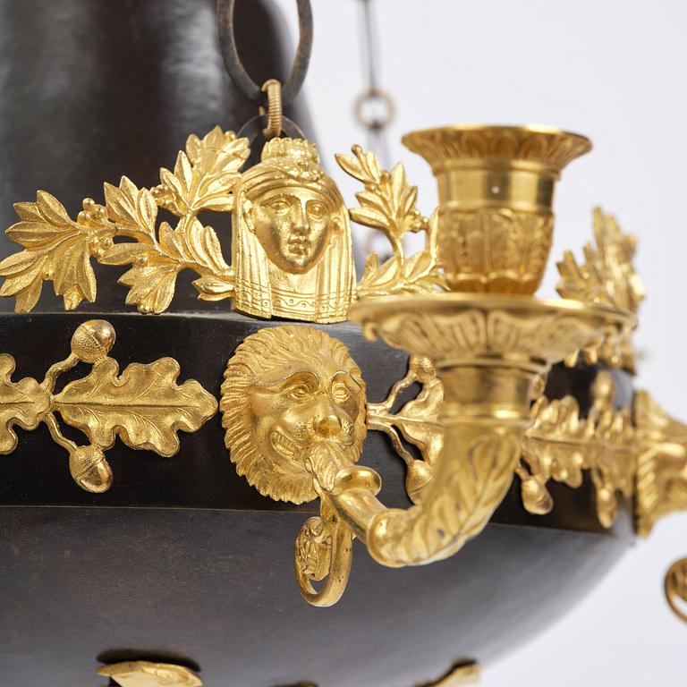 A patinated and ormolu six-light Empire chandelier, Stockholm, first part 19th century.