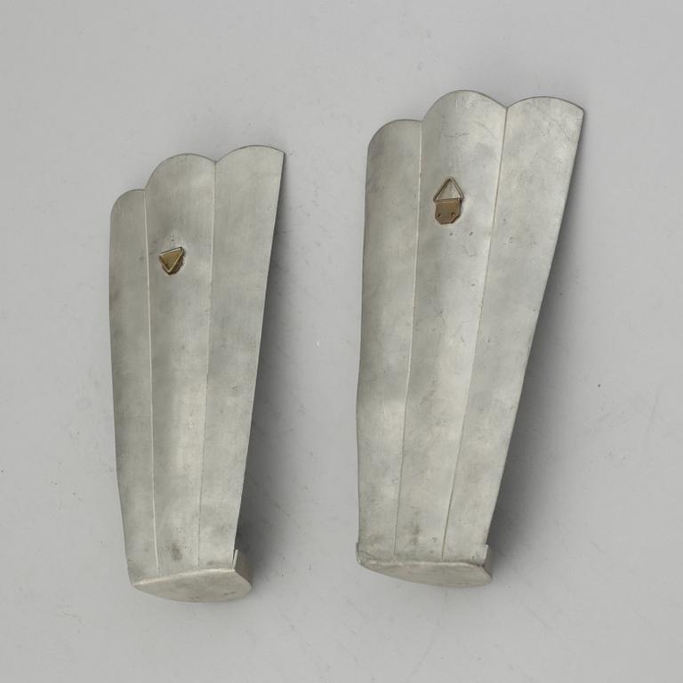 Firma Svenskt Tenn, a pair of pewter and brass wall sconces, Sweden 1925.