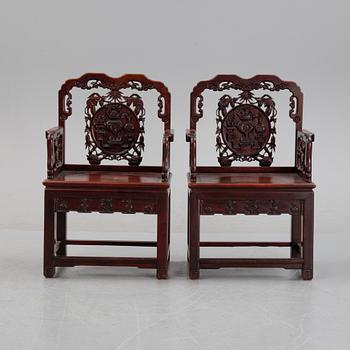A pair of Chinese hardwood armchairs, presumably late Qing dynasty 19th century.