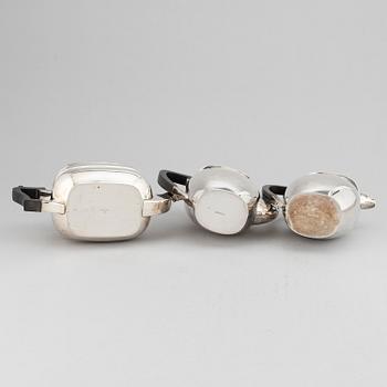 A silver teapot, coffee pot and a hot water pot, including Atkins Brothers, Sheffield 1944.