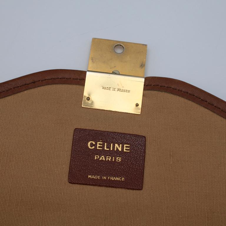 CÉLINE, a grey clutch bag.